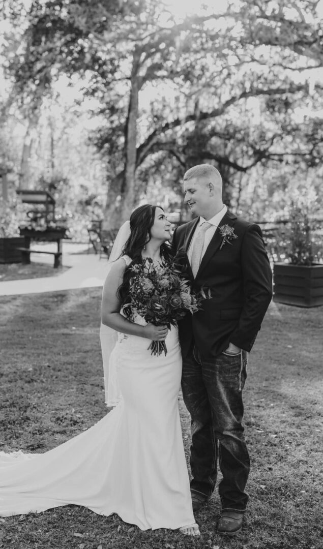 A joyful bride and groom share a loving moment outdoors.