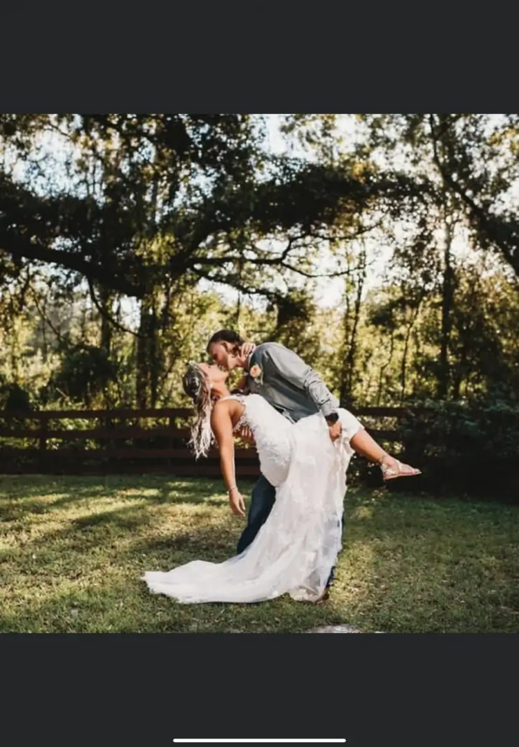 Bride and groom sharing a romantic dance outdoors.
