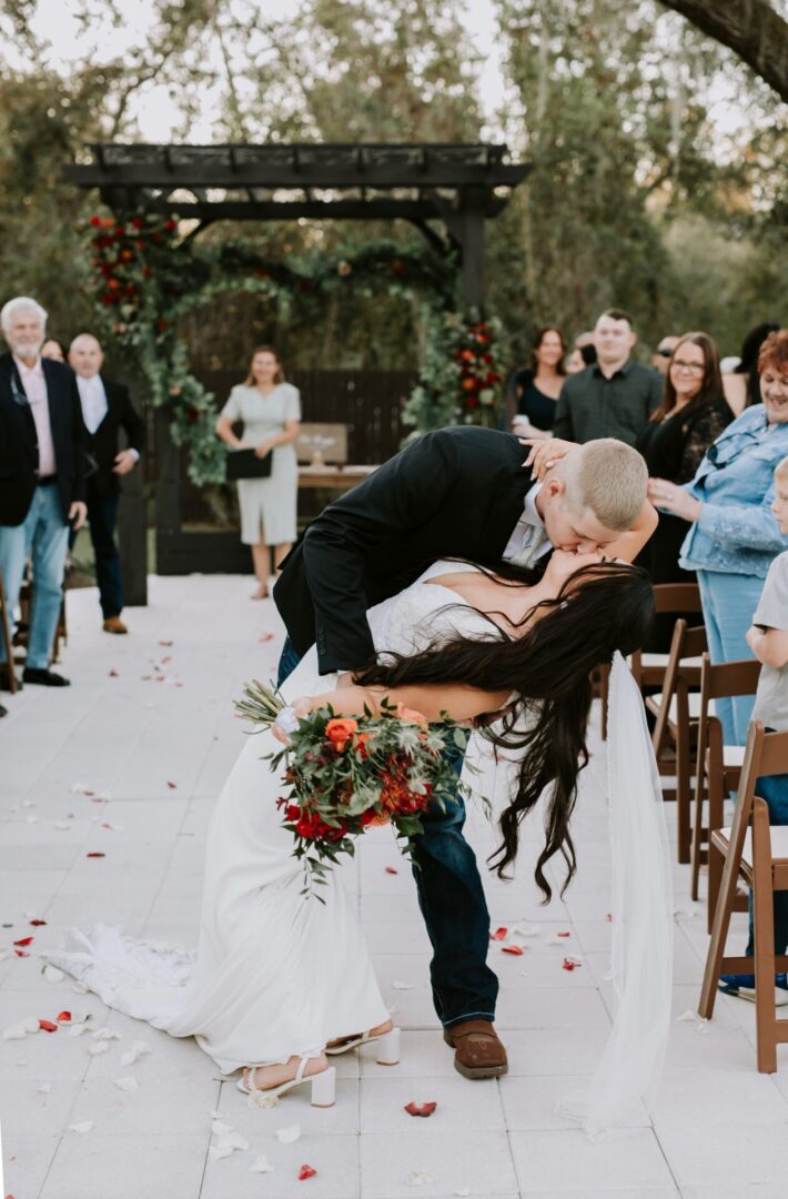 Bride and groom kissing at outdoor wedding.