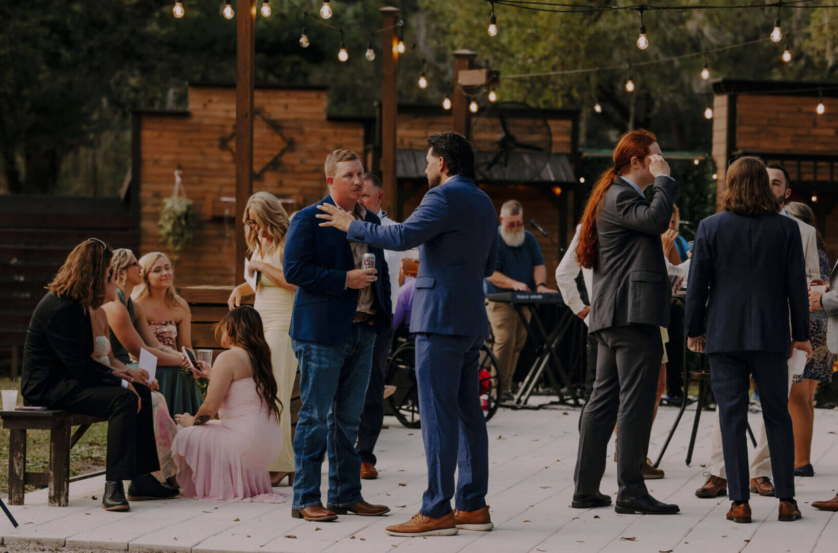 Outdoor social gathering with people conversing.
