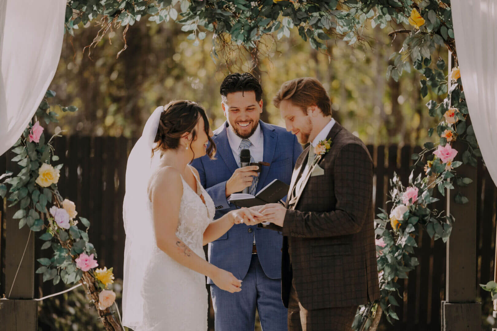 Bride and groom exchanging vows outdoors.
